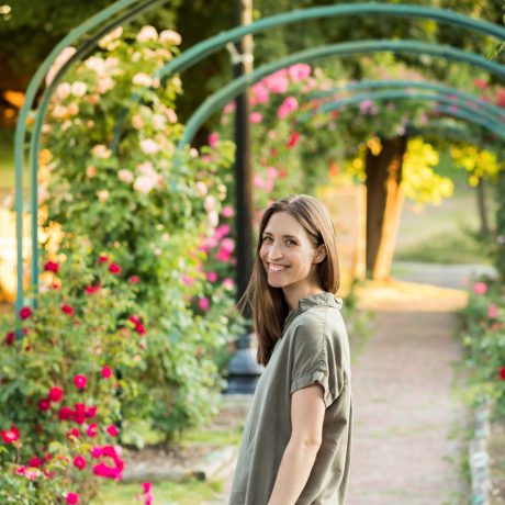 Holistic practitioner and functional medicine practitioner in Syracuse NY smiling in a garden setting, providing holistic health services in Central New York.